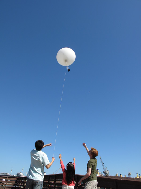 Sum is going to jump up and catch the balloon...