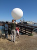 Mark grabs the gondola and secures the balloon.