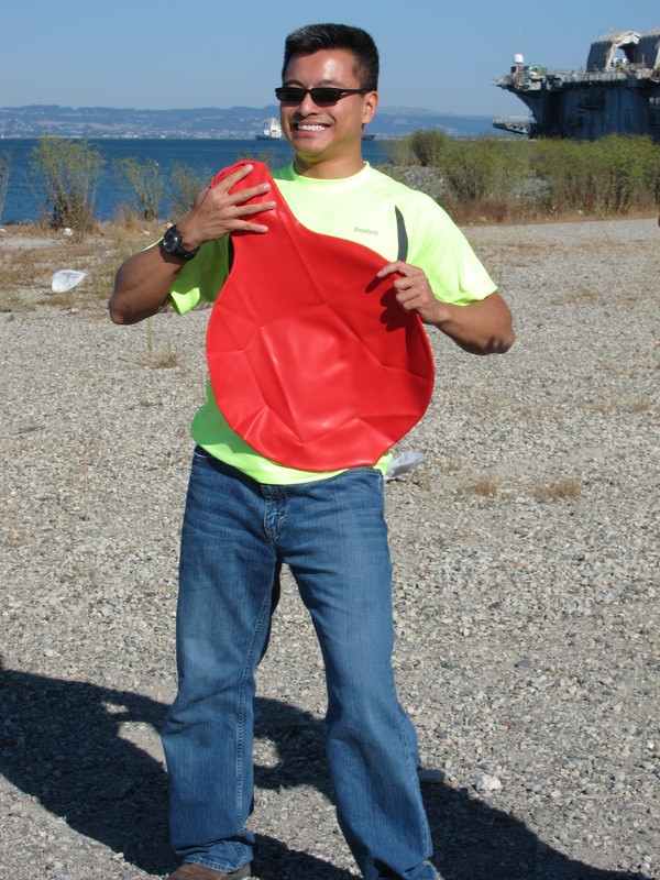 Simon with the uninflated Big Red Balloon. In red, a dead ringer for an enormous whoopee cushion!