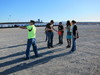 Simon takes a turn hauling in the balloon, while Erica, Tingting, and Karen watch.