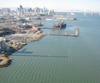 The San Francisco central waterfront, with a view of the dry docks, the Bay Bridge, and the downtown skyline.