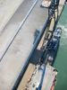 The tugboat attached to the ex-USS Tripoli, which Simon IDed as the USNS Narragansett.