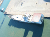 An unidentified third boat (other than Tripoli and Narragansett) on the east side of the dock.