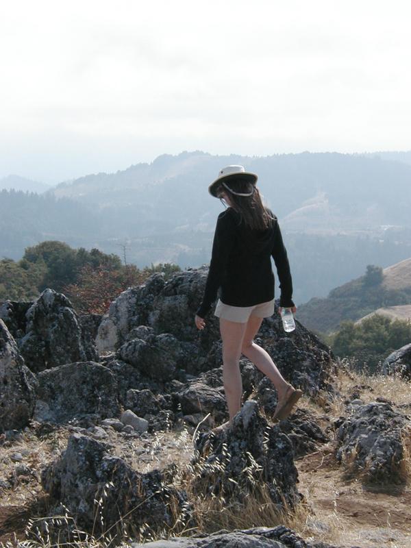 Holly walking towards the rocky formations at the summit