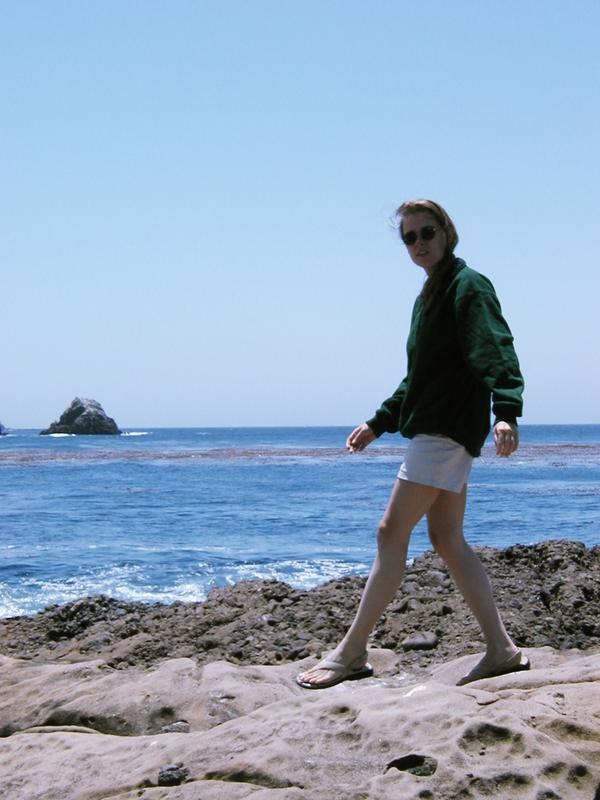 Holly walking along the shore