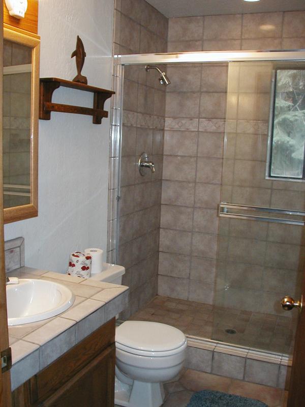 Across from the downstairs bedroom is a bathroom with a shower