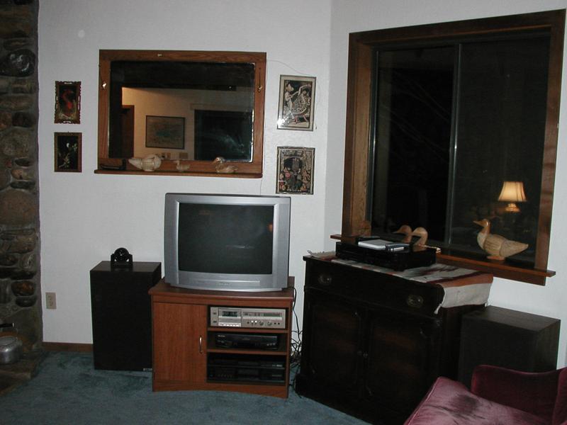 A decent Philips TV and some ancient A/V equipment are in the living room
