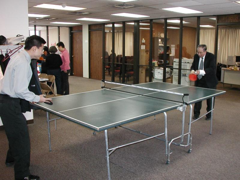 Simon and my dad playing ping-pong at church