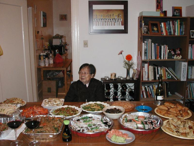 My grandmother in front of a table of food
